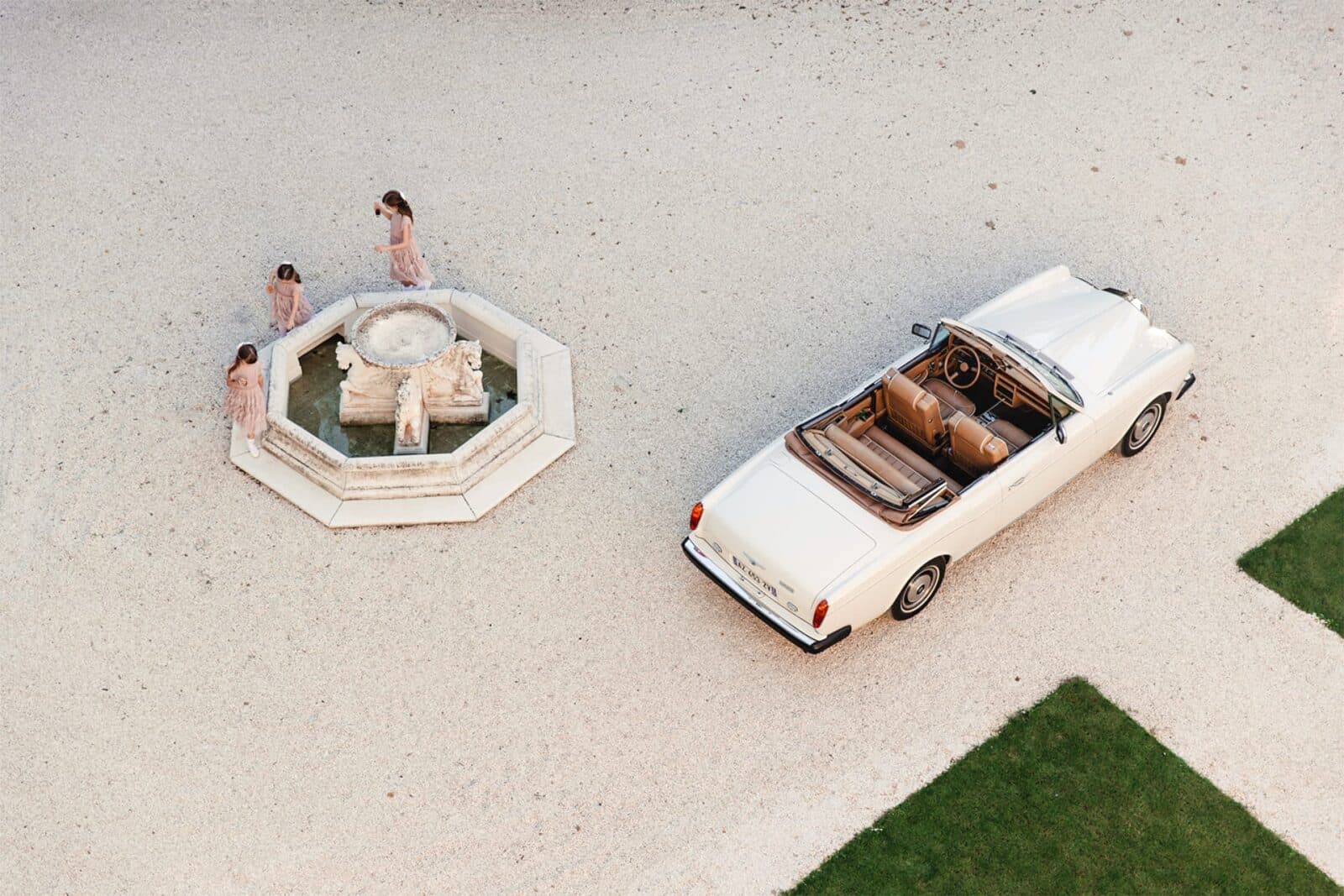 Classic wedding car in chateau courtyard